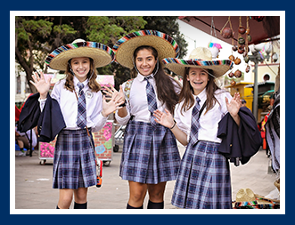 Three female students wear sombreros